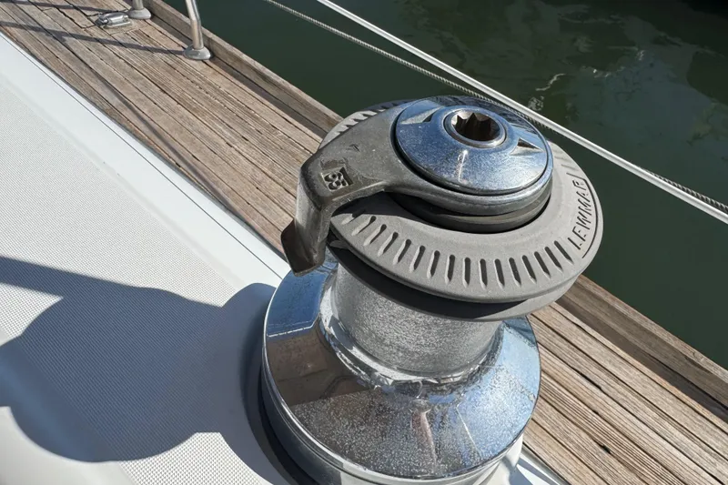 Slide: The Image of Winch on 2007 Beneteau Oceanis 49 sailboat deck, near wooden dock. - 23