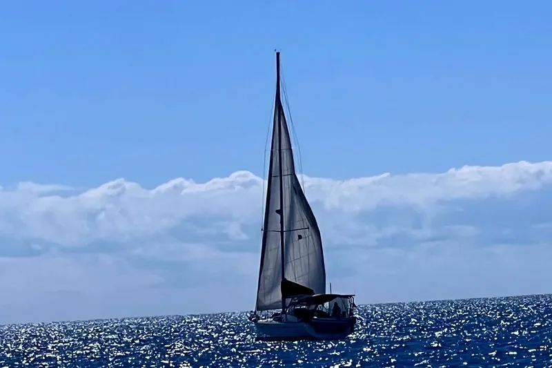 Slide: The Image of Sailing yacht Beneteau 49 (2007) gliding on sparkling ocean under clear blue sky. - 24