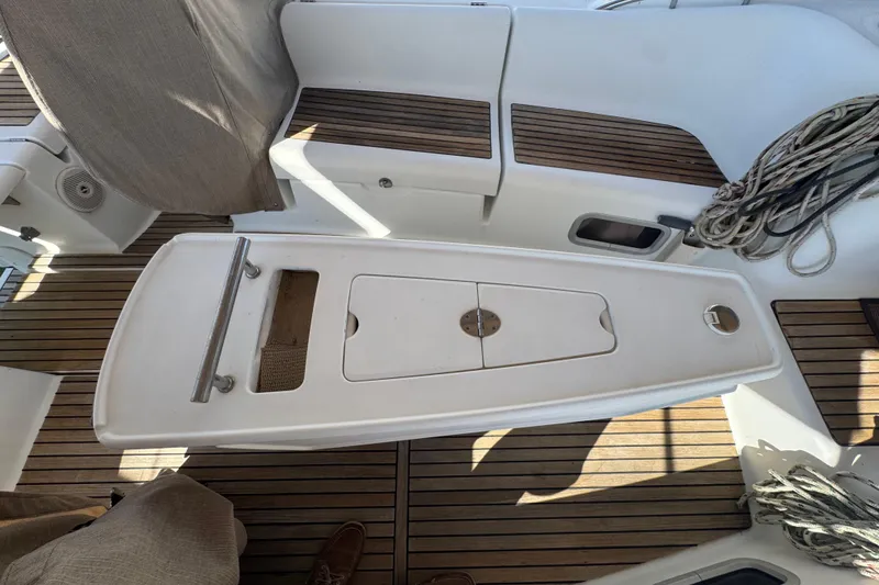 Slide: The Image of Cockpit of 2007 Beneteau Oceanis 49 sailboat with teak flooring and storage compartments. - 29