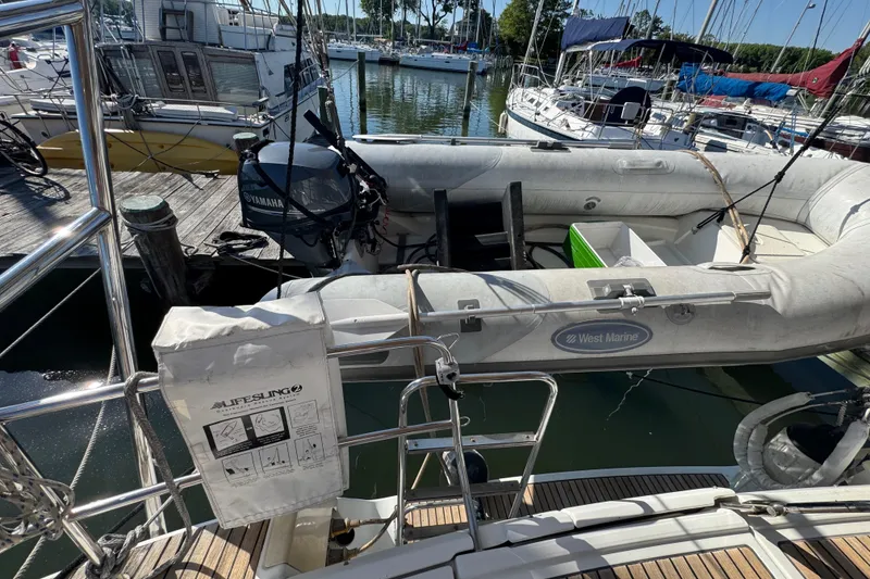 Slide: The Image of Beneteau Oceanis 49 (2007) yacht with West Marine dinghy and Yamaha motor at dock. - 33