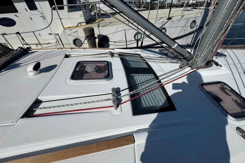 Slide: The Image of Deck view of a 2007 Beneteau Oceanis 49 sailboat, featuring rigging and hatches. - 38