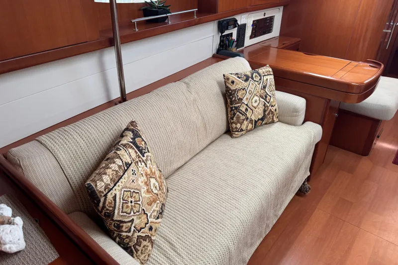 Slide: The Image of Interior of 2007 Beneteau Oceanis 49 yacht with cozy sofa and patterned cushions. - 4