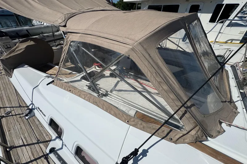 Slide: The Image of 2007 Beneteau Oceanis 49 sailboat with beige canopy docked at marina. - 42