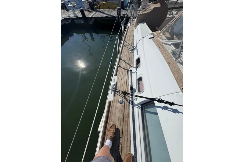 Slide: The Image of Deck view of a 2007 Beneteau Oceanis 49 sailboat docked at a marina. - 43