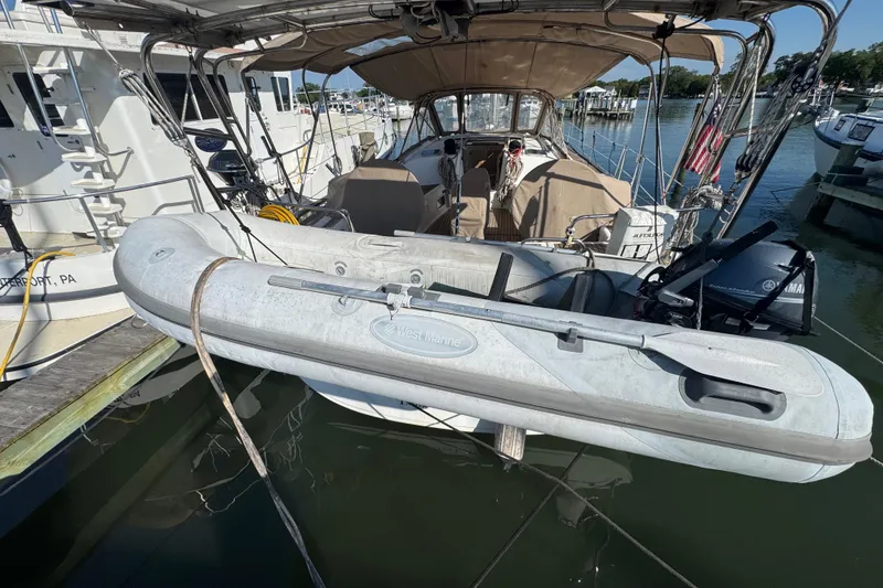 Slide: The Image of Beneteau Oceanis 49 sailboat with dinghy, docked at marina, 2007 model. - 49