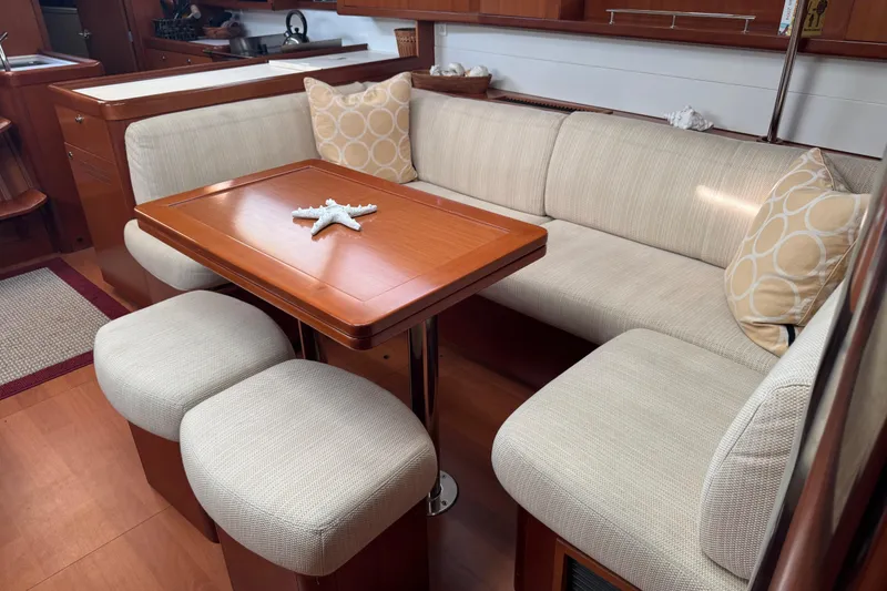Slide: The Image of Luxurious interior of 2007 Beneteau Oceanis 49 yacht with elegant seating and wooden table. - 5