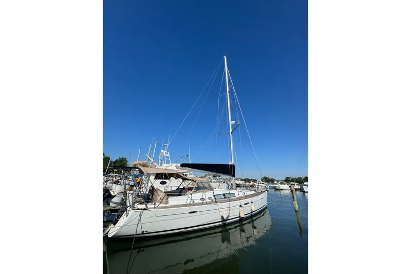 Slide: The Image of 2007 Beneteau Oceanis 49 sailboat docked in a marina under clear blue skies. - 51