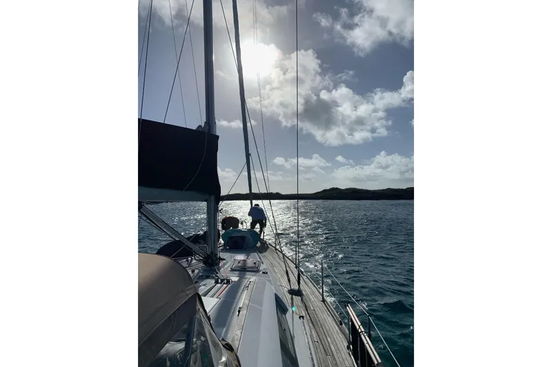 Slide: The Image of Sailing on a 2007 Beneteau 49 yacht under a sunny sky, with scenic ocean views. - 56