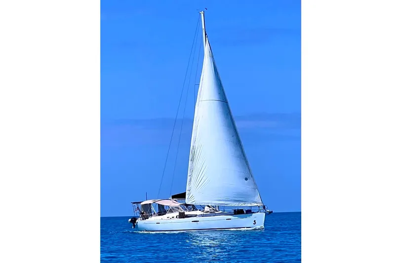Slide: The Image of 2007 Beneteau 49 sailboat cruising on calm blue waters under clear skies. - 57