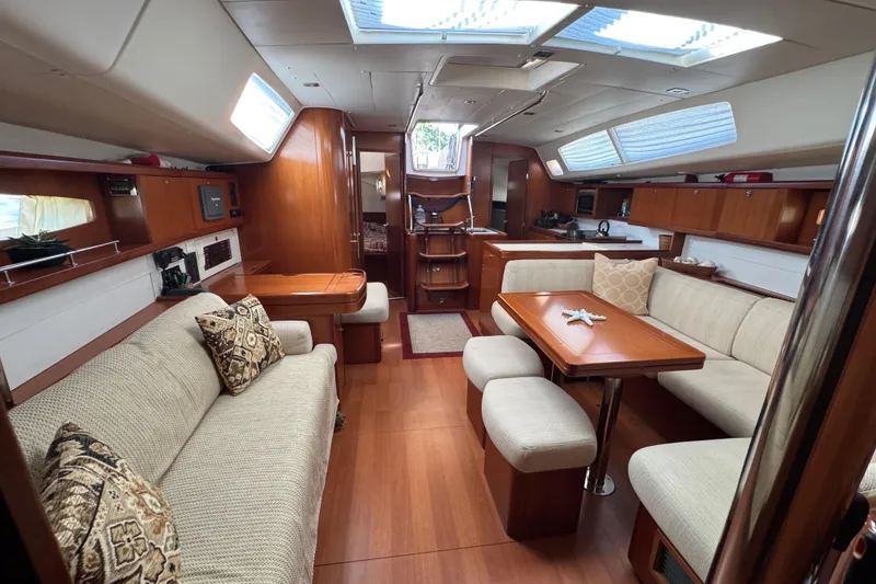Slide: The Image of Luxurious interior of 2007 Beneteau Oceanis 49 yacht with elegant wood finish and plush seating. - 6