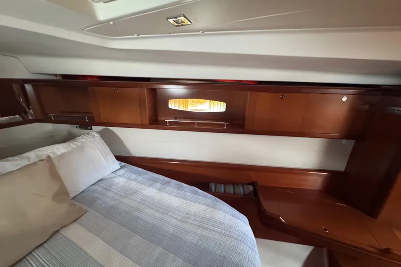 Slide: The Image of Luxurious cabin interior of 2007 Beneteau Oceanis 49 yacht with wooden cabinetry and cozy bedding. - 7