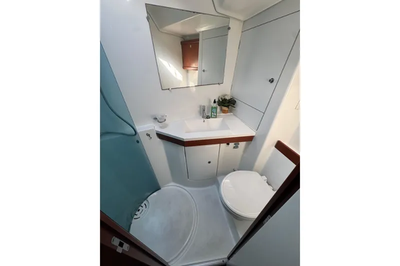 Slide: The Image of Compact bathroom in 2007 Beneteau Oceanis 49 yacht, featuring sink, mirror, and toilet. - 8