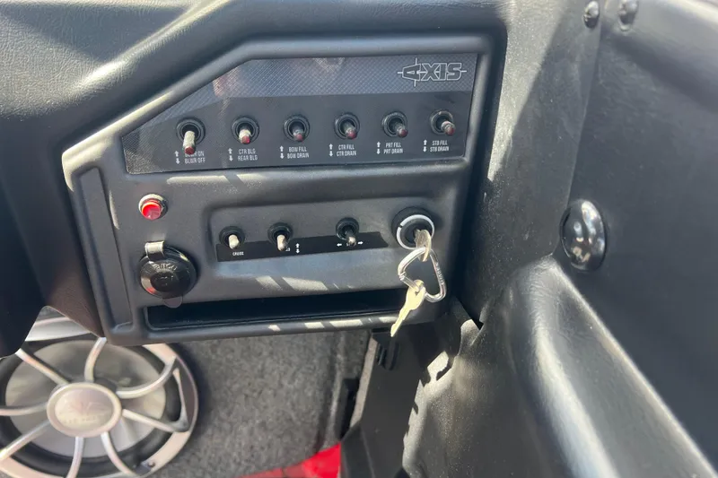 Slide: The Image of Control panel of a 2016 Axis T22 boat with switches and ignition keys. - 16