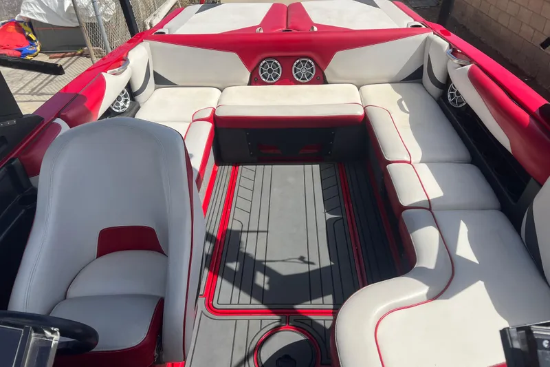 Slide: The Image of 2016 Axis T22 boat interior with red and white seating, featuring modern design and speakers. - 17