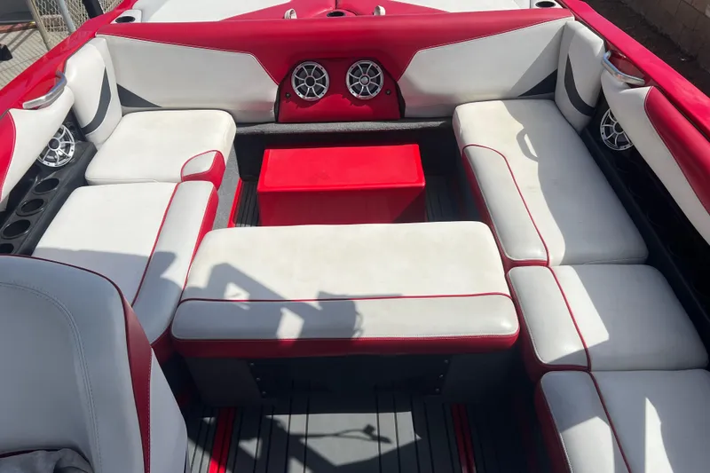 Slide: The Image of Interior of 2016 Axis T22 boat with red and white seating and speakers. - 18