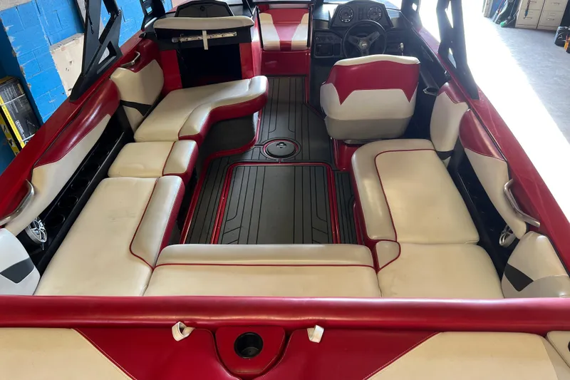 Slide: The Image of Interior of a 2016 Axis T22 boat with red and white seating. - 2