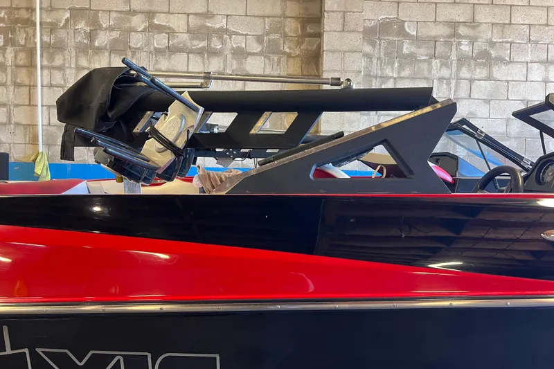 Slide: The Image of 2016 Axis T22 boat in a garage, featuring a sleek red and black design. - 22