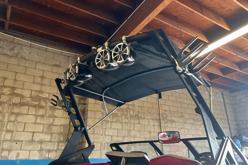 Slide: The Image of 2016 Axis T22 boat tower with speakers and wakeboard racks in a garage setting. - 24