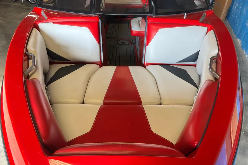Slide: The Image of Red and white interior of a 2016 Axis T22 boat, featuring cushioned seating. - 25