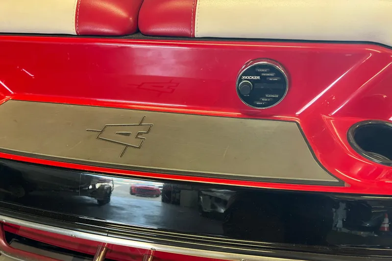 Slide: The Image of 2016 Axis T22 boat interior with red and beige seating, Kicker audio control. - 27