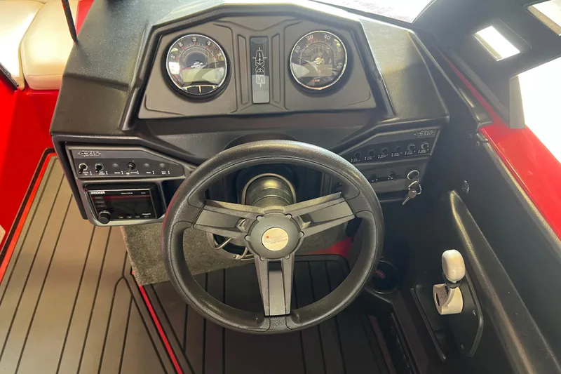 Slide: The Image of 2016 Axis T22 boat dashboard with steering wheel and control panel. - 28