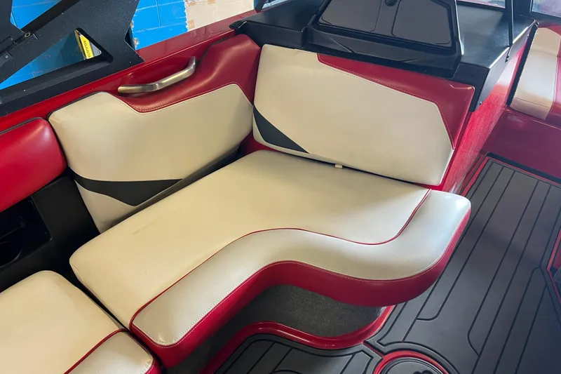 Slide: The Image of 2016 Axis T22 boat interior with red and white seating and sleek design. - 29