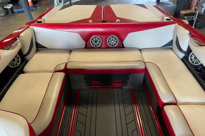 Slide: The Image of Interior of 2016 Axis T22 boat with red and white seating and speakers. - 3