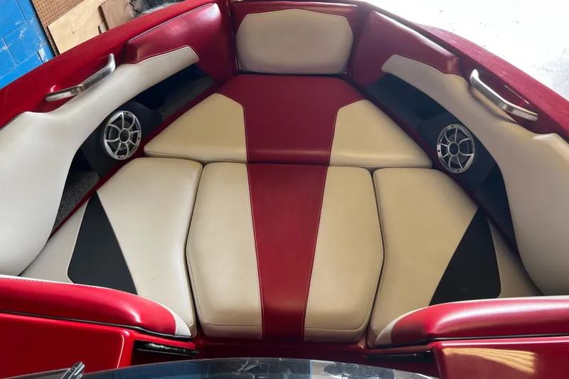 Slide: The Image of 2016 Axis T22 boat interior with red and beige seating, featuring built-in speakers. - 33