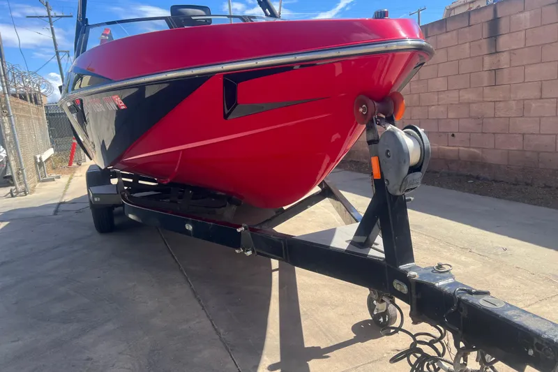 Slide: The Image of Red 2016 Axis T22 boat on trailer, parked on concrete driveway. - 37
