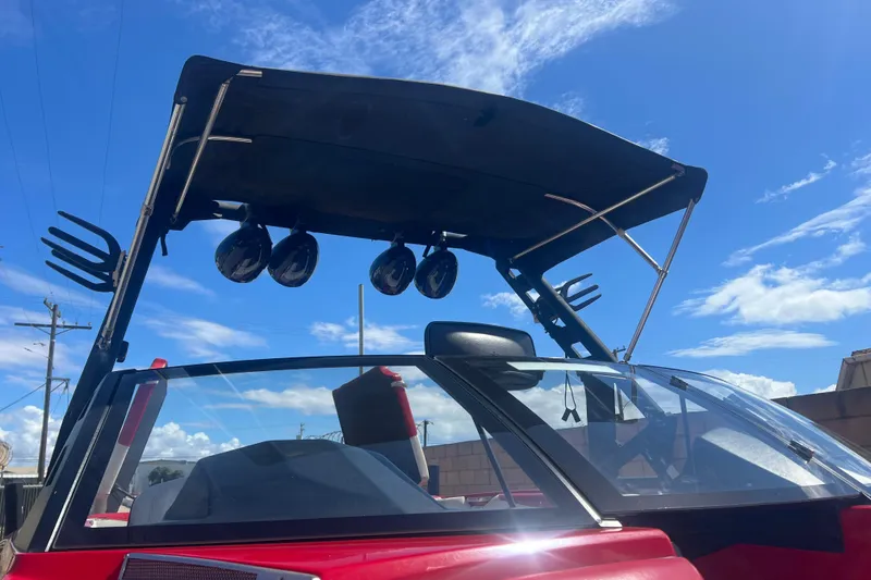 Slide: The Image of 2016 Axis T22 boat with speakers and wakeboard racks under a clear blue sky. - 39
