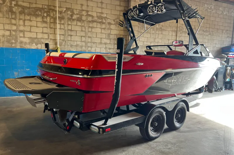 Slide: The Image of Red 2016 Axis T22 boat on trailer in a garage setting. - 4