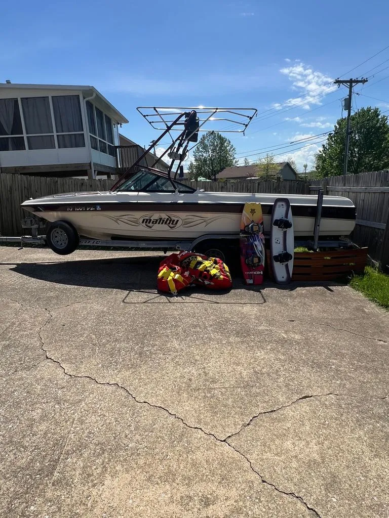 The Image of 1997 Malibu Sunsetter LX boat with watersport gear outdoors. - 0