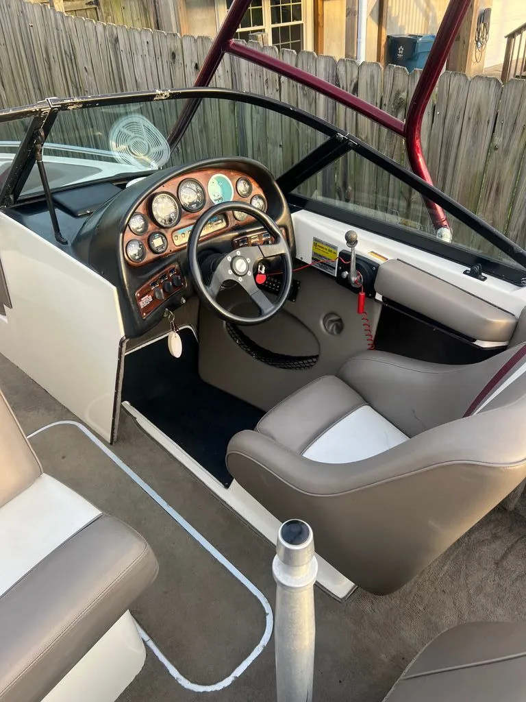 Slide: The Image of Interior of a 1997 Malibu Sunsetter LX boat with steering console. - 3