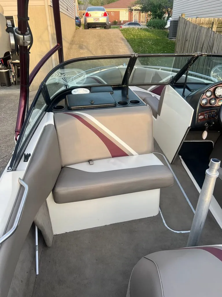 Slide: The Image of Interior of a 1997 Malibu Sunsetter LX boat with gray and red seating. - 4