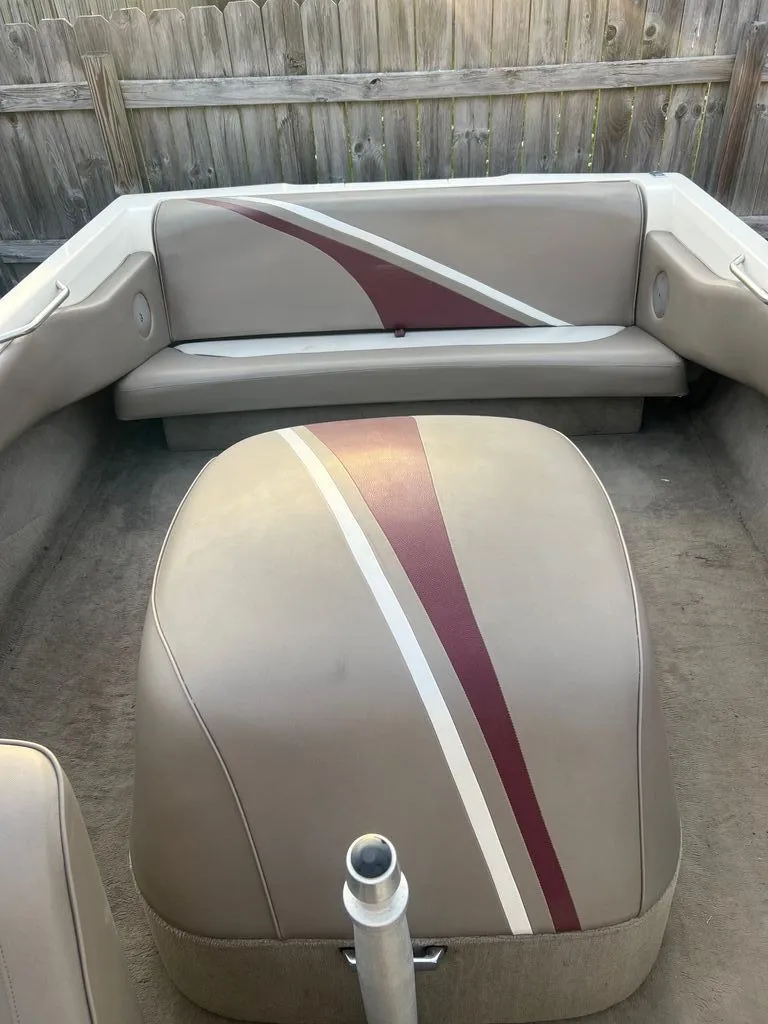 Slide: The Image of Interior of a 1997 Malibu Sunsetter LX boat with striped seats. - 5