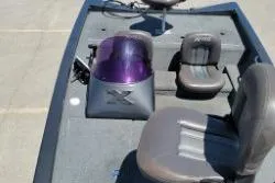 Slide: The Image of 2007 Xpress X17 boat interior with seating and console, featuring a purple windshield. - 10