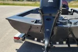 Slide: The Image of 2007 Xpress X17 boat with outboard motor on trailer, parked outdoors. - 11