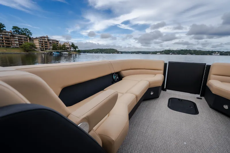 Slide: The Image of Luxurious Evotti 525QL boat interior with beige seating, overlooking a serene lake view. - 22