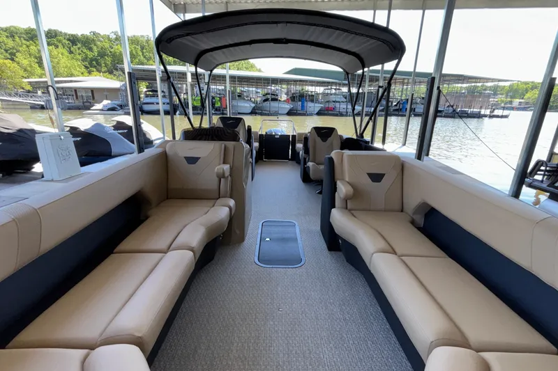 Slide: The Image of Luxurious 2026 Evotti 525QL pontoon boat interior with spacious seating at a marina. - 13