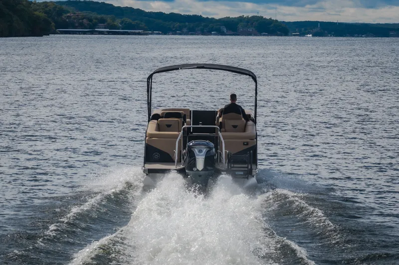 Slide: The Image of Evotti 525QL boat cruising on a lake, 2026 model, rear view. - 75