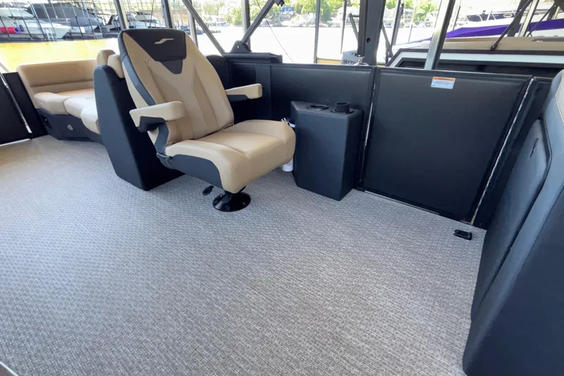 Slide: The Image of 2026 Evotti 525QL boat interior with beige captain's chair and carpeted flooring. - 17