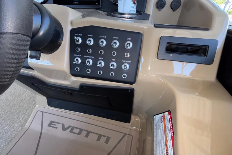 Slide: The Image of Control panel of 2026 Evotti 525QL boat with labeled switches and steering wheel. - 22