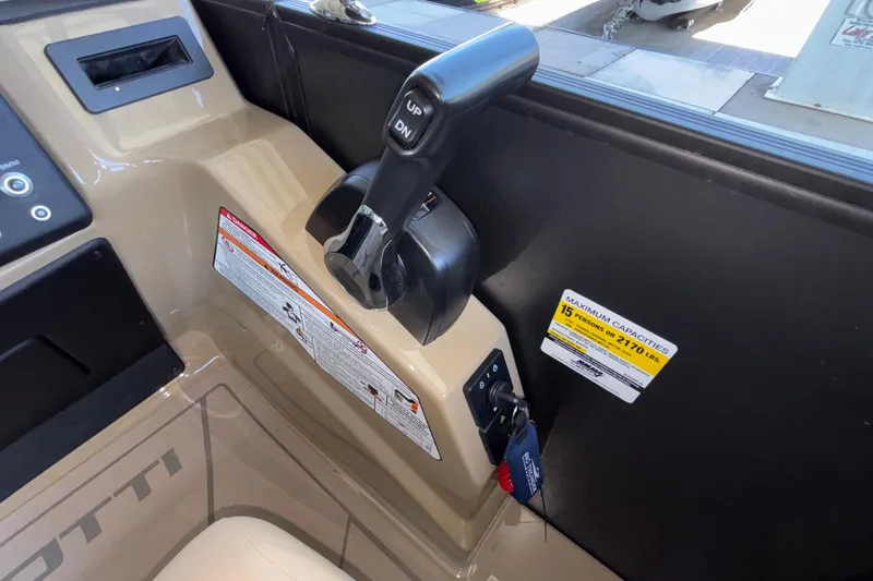 Slide: The Image of Control panel of 2026 Evotti 525QL boat with capacity label and throttle lever. - 23