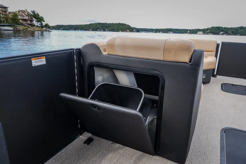 Slide: The Image of 2026 Evotti 525QL boat interior with open storage compartment, lake view in background. - 42