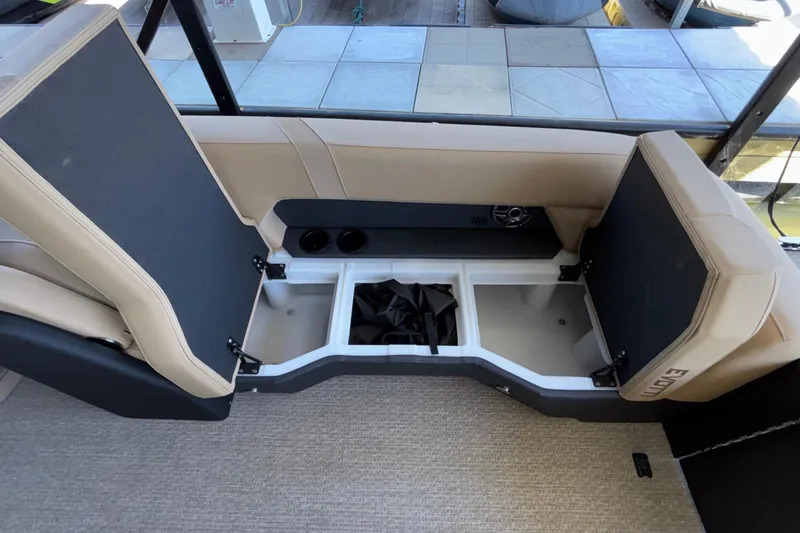 Slide: The Image of Interior seating and storage of 2026 Evotti 525QL boat, featuring beige upholstery and open compartments. - 34