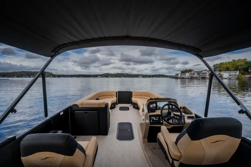 Slide: The Image of Luxury Evotti 525QL pontoon boat interior on a serene lake, 2026 model. - 38