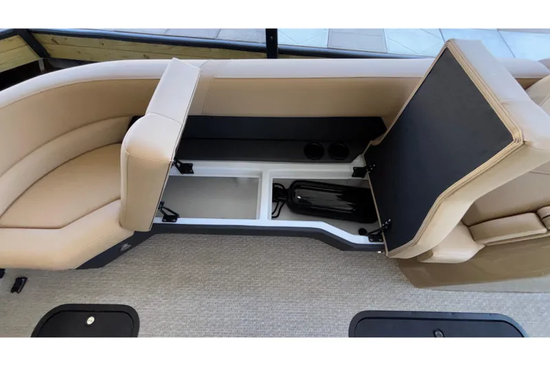 Slide: The Image of Evotti 525QL 2026 boat interior with open storage compartment and beige seating. - 38