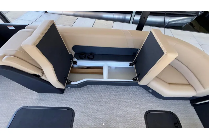 Slide: The Image of 2026 Evotti 525QL boat interior with open storage compartments and beige seating. - 40