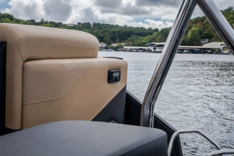 Slide: The Image of 2026 Evotti 525QL boat interior with beige seating, overlooking a scenic lake view. - 58