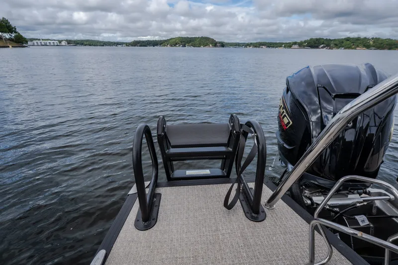 Slide: The Image of Evotti 525QL 2026 boat with motor, on a calm lake under cloudy skies. - 61